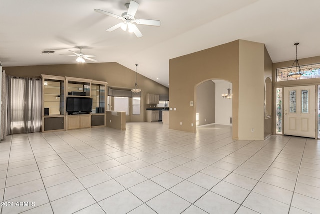 unfurnished living room featuring light tile patterned flooring, ceiling fan with notable chandelier, and vaulted ceiling