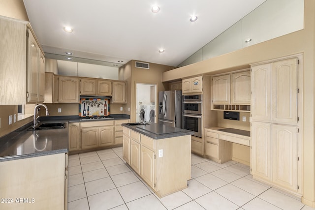 kitchen with a center island with sink, stainless steel appliances, light brown cabinets, sink, and washing machine and clothes dryer