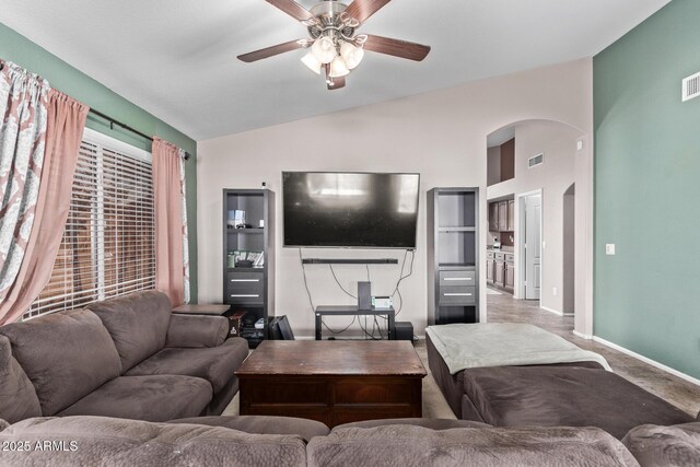 living room featuring lofted ceiling, light colored carpet, and ceiling fan