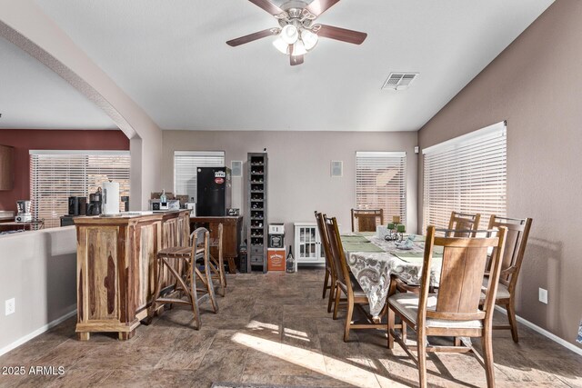 dining area featuring vaulted ceiling and ceiling fan