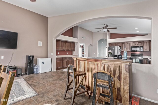 kitchen with sink, black appliances, ceiling fan, and a kitchen island