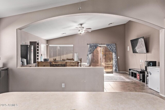 kitchen featuring refrigerator and a high ceiling