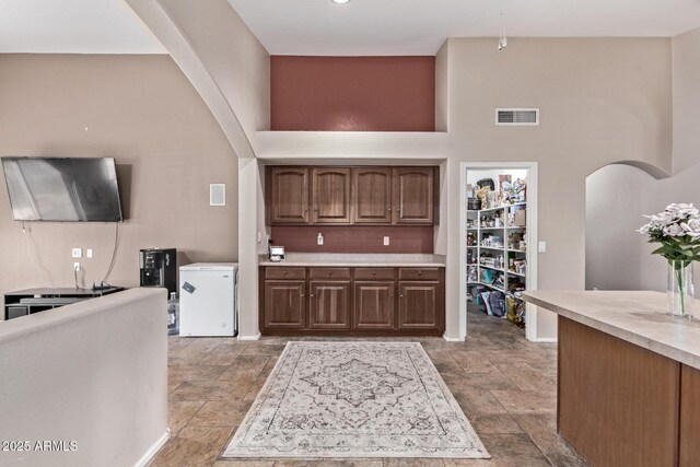 bathroom featuring vanity, lofted ceiling, and an enclosed shower