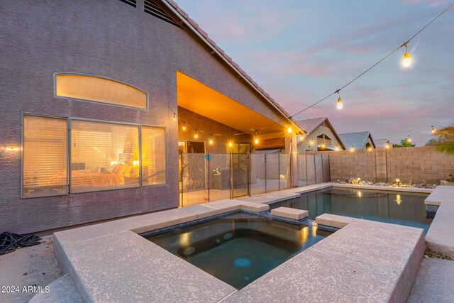 view of pool featuring a patio area and an in ground hot tub