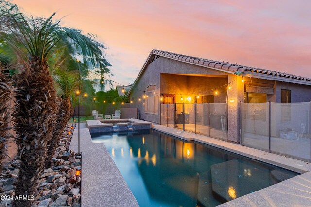 view of swimming pool with a patio and an in ground hot tub