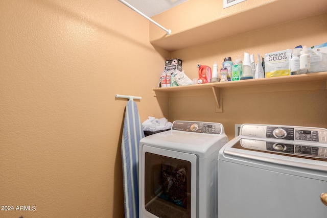 clothes washing area with washer and clothes dryer