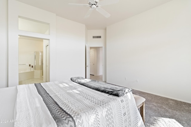 carpeted bedroom with ensuite bathroom and ceiling fan