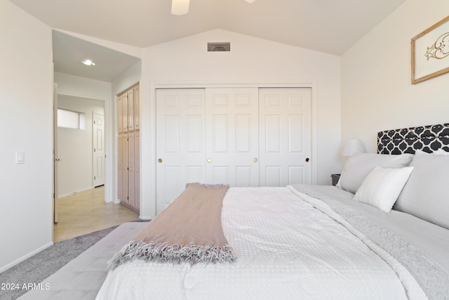 carpeted bedroom featuring ceiling fan and vaulted ceiling