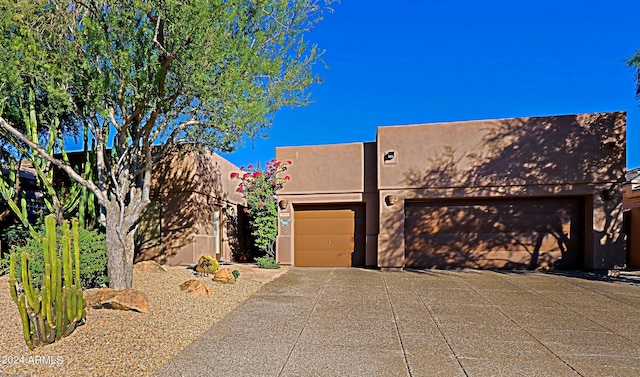 pueblo-style house with a garage