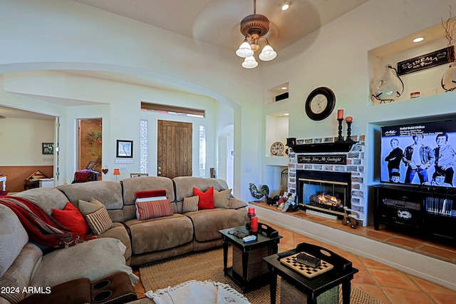 living room featuring built in features, light tile patterned floors, and a fireplace