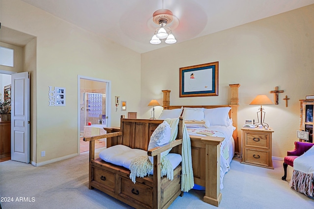 carpeted bedroom featuring ceiling fan and ensuite bath