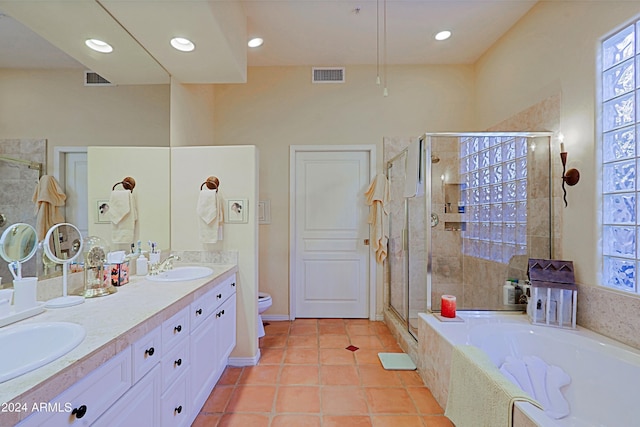 full bathroom featuring toilet, shower with separate bathtub, vanity, and tile patterned flooring