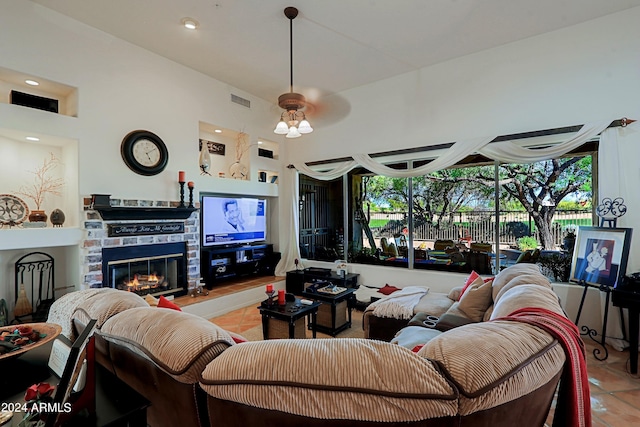 living room with light tile patterned floors and a fireplace