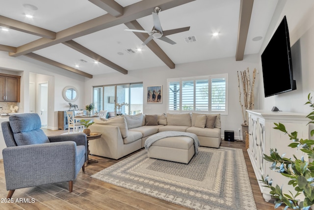 living room with light wood-type flooring, a healthy amount of sunlight, and visible vents