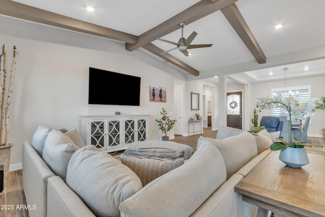 living area featuring vaulted ceiling with beams, recessed lighting, ceiling fan with notable chandelier, wood finished floors, and baseboards