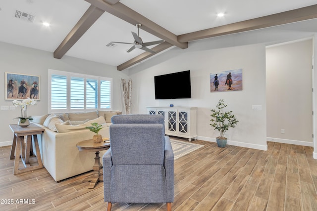 living room featuring lofted ceiling with beams, a ceiling fan, baseboards, visible vents, and wood tiled floor