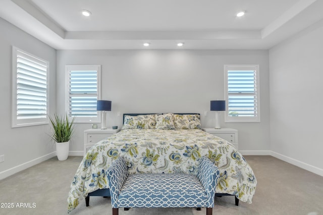 carpeted bedroom with a tray ceiling, baseboards, and recessed lighting