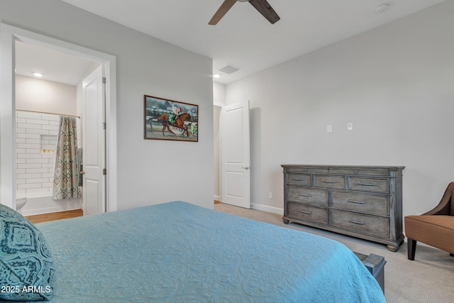 bedroom featuring visible vents, light carpet, connected bathroom, ceiling fan, and baseboards