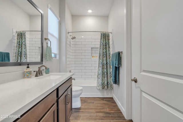 full bathroom featuring toilet, wood finish floors, vanity, baseboards, and shower / bath combination with curtain