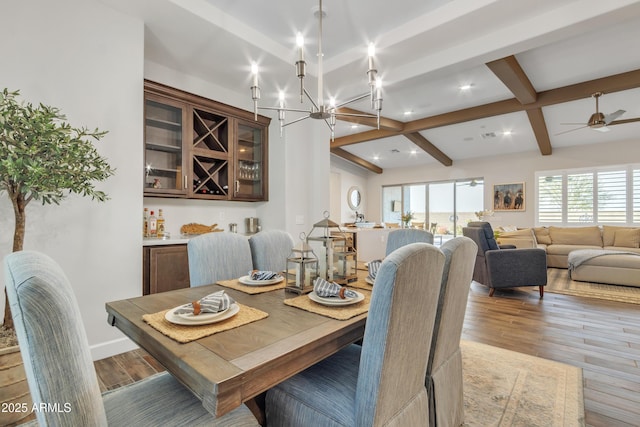 dining area featuring recessed lighting, light wood-style floors, beamed ceiling, baseboards, and ceiling fan with notable chandelier