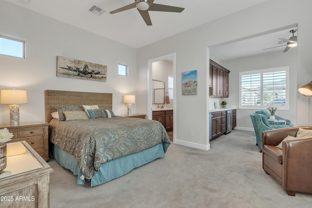 bedroom with light colored carpet, visible vents, baseboards, and multiple windows