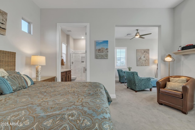 bedroom featuring ensuite bath, baseboards, ceiling fan, and carpet flooring