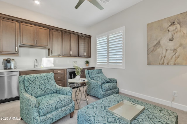 living area with a ceiling fan and baseboards