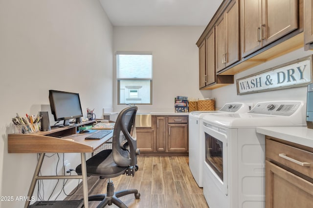 laundry area featuring cabinet space, independent washer and dryer, and light wood finished floors