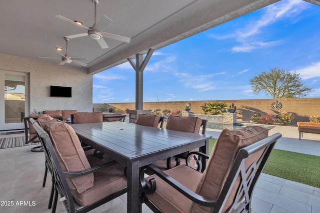 view of patio with ceiling fan, a fenced backyard, and outdoor dining space