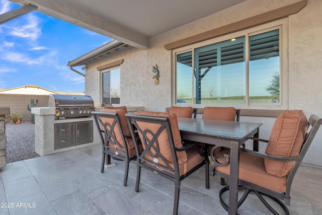 view of patio with a grill, exterior kitchen, and outdoor dining space