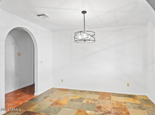 unfurnished dining area with a notable chandelier