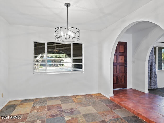 foyer entrance with an inviting chandelier