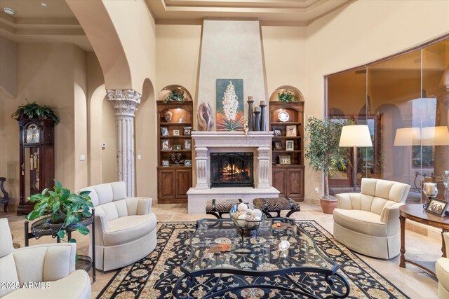 15956 E Tombstone Trl, Fountain Hills, AZ 85268 - living room with a large fireplace, built in features, decorative columns, a high ceiling, and arched walkways