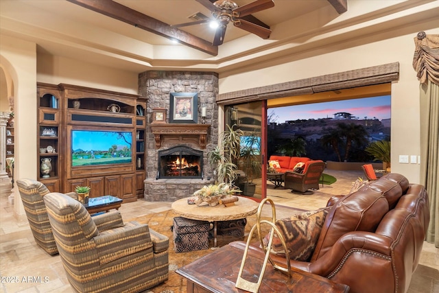 15956 E Tombstone Trl, Fountain Hills, AZ 85268 - living room featuring beamed ceiling, arched walkways, a ceiling fan, and a fireplace