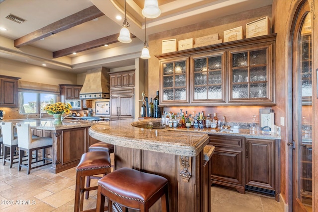 15956 E Tombstone Trl, Fountain Hills, AZ 85268 - kitchen with visible vents, stainless steel microwave, stone tile floors, a center island, and custom exhaust hood