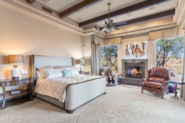 15956 E Tombstone Trl, Fountain Hills, AZ 85268 - bedroom featuring a high end fireplace, visible vents, beamed ceiling, and carpet