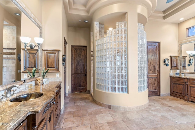 15956 E Tombstone Trl, Fountain Hills, AZ 85268 - full bath with two vanities, a sink, recessed lighting, baseboards, and a towering ceiling