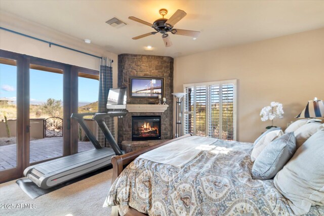 15956 E Tombstone Trl, Fountain Hills, AZ 85268 - carpeted bedroom with a stone fireplace, multiple windows, visible vents, and access to outside