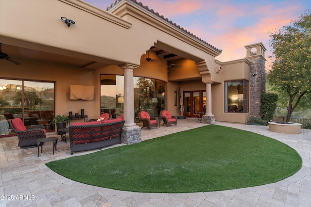 15956 E Tombstone Trl, Fountain Hills, AZ 85268 - patio terrace at dusk featuring an outdoor living space, a yard, and a ceiling fan