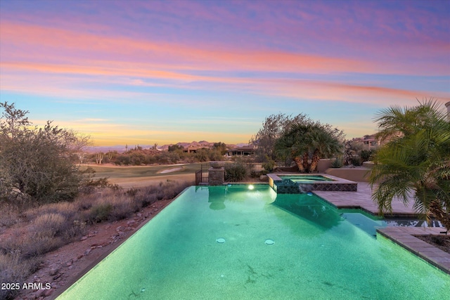 15956 E Tombstone Trl, Fountain Hills, AZ 85268 - pool at dusk featuring a pool with connected hot tub