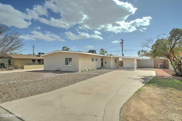 ranch-style home with brick siding, fence, and central air condition unit