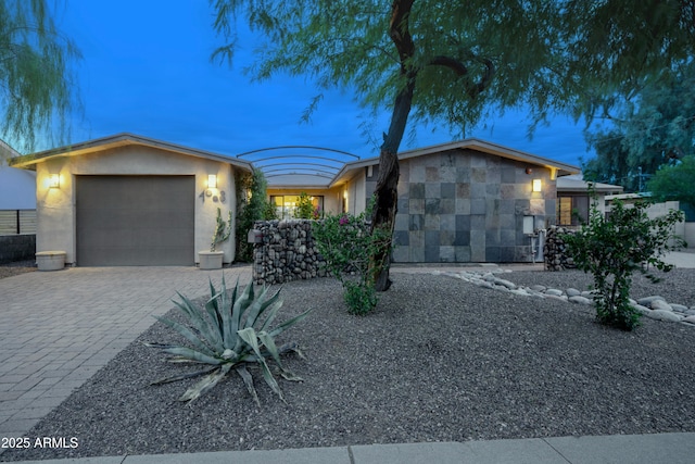 4008 N 85th St, Scottsdale, AZ 85251 - view of front facade with a garage, stucco siding, and decorative driveway
