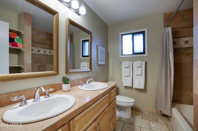 4008 N 85th St, Scottsdale, AZ 85251 - full bath featuring double vanity, toilet, stone tile floors, shower / bathtub combination with curtain, and baseboards