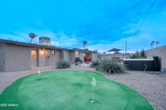4008 N 85th St, Scottsdale, AZ 85251 - back of property with a putting green, a fenced backyard, and stucco siding