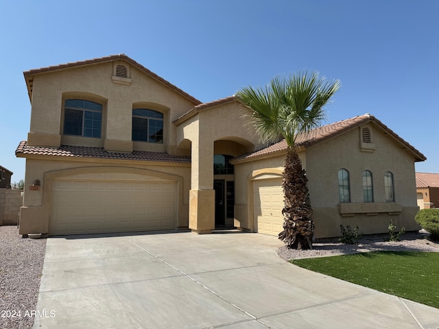 mediterranean / spanish house featuring a garage