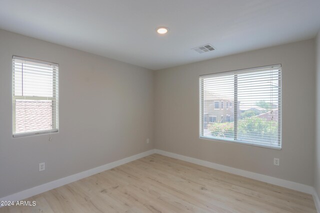 spare room featuring light hardwood / wood-style floors