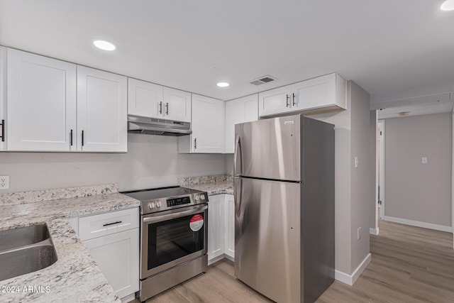 kitchen featuring light stone countertops, stainless steel appliances, sink, light hardwood / wood-style flooring, and white cabinetry