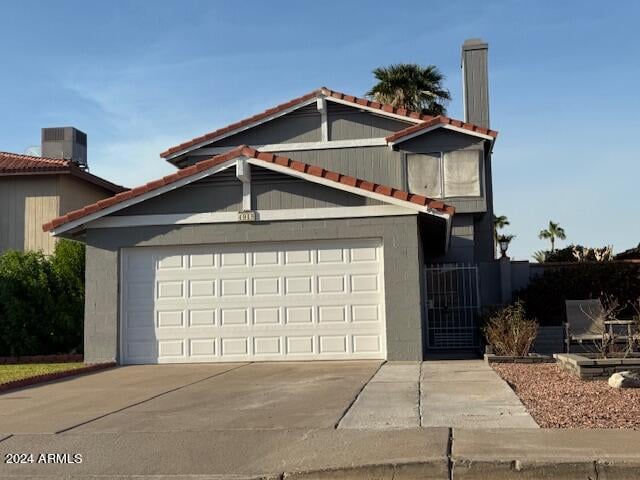 exterior space with cooling unit and a garage