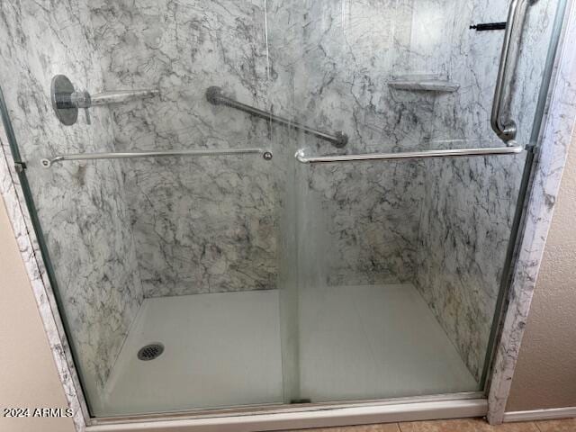 bathroom with a shower with door