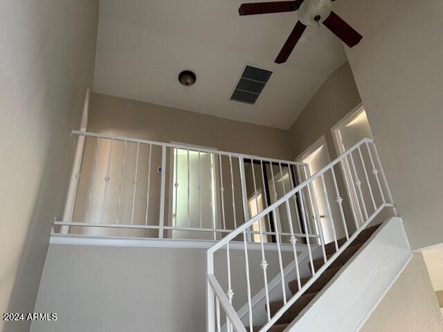 stairway featuring lofted ceiling